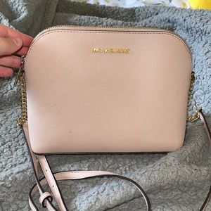 Light pink/gold Michael Kors crossbody bag. Very cute but just sits in my closet